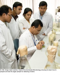 Dr. Md. Sirajul Islam (centre) shows his team how to test an algae sample for Cholera. © icddr,b