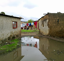 During rainy season this area is flooded, roads are full of ditches with muddy water and pit toilets are flooded with rain water, in Lusaka, Zambia © Sustainable Sanitation Alliance