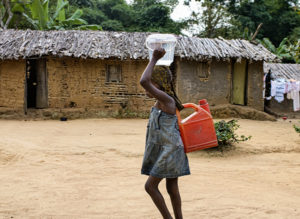 Girl carrying water; Credit: Olliver Girard/CIFOR