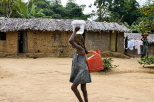 Girl carrying water; credit Ollivier Girard Center for International Forestry Research (CIFOR)