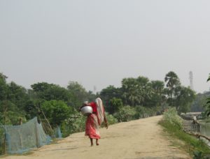 Woman walking with a water jar in Polder 29, Khulna district. Credit: Md Jobayer Hossain