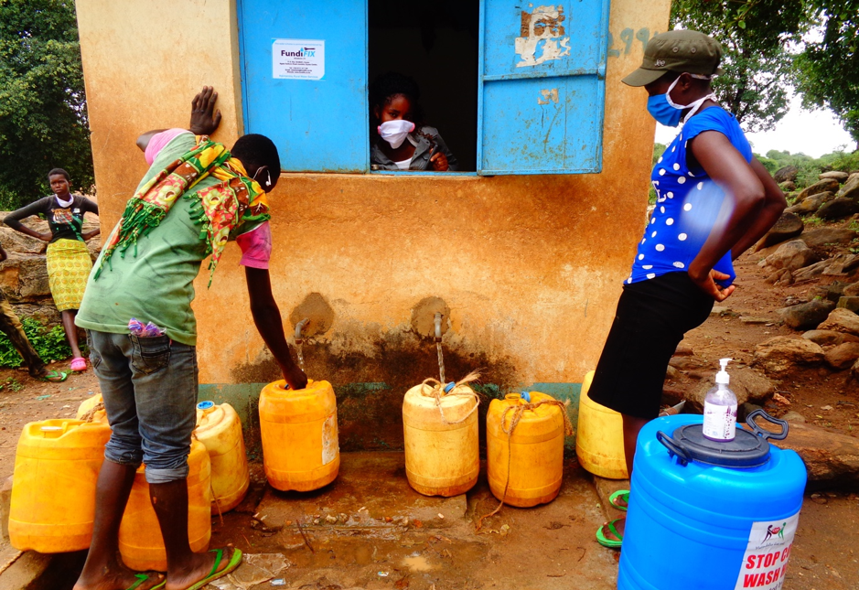 Water collection at a kiosk in Kitui, Kenya, during the COVID19 pandemic. April 2020; Credit: Mary Musenya Sammy