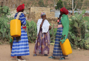 Women talking while carrying water jerrycans, on the outskirt of Wukro, Ethiopia (Credit: Marina Korzenevica)