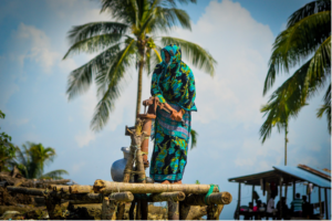 A woman drawing water from a hand pump in Bangladesh