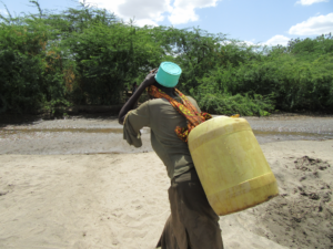 Woman carrying a water jug in Turkana County, Kenya. Credit: Rob Hope