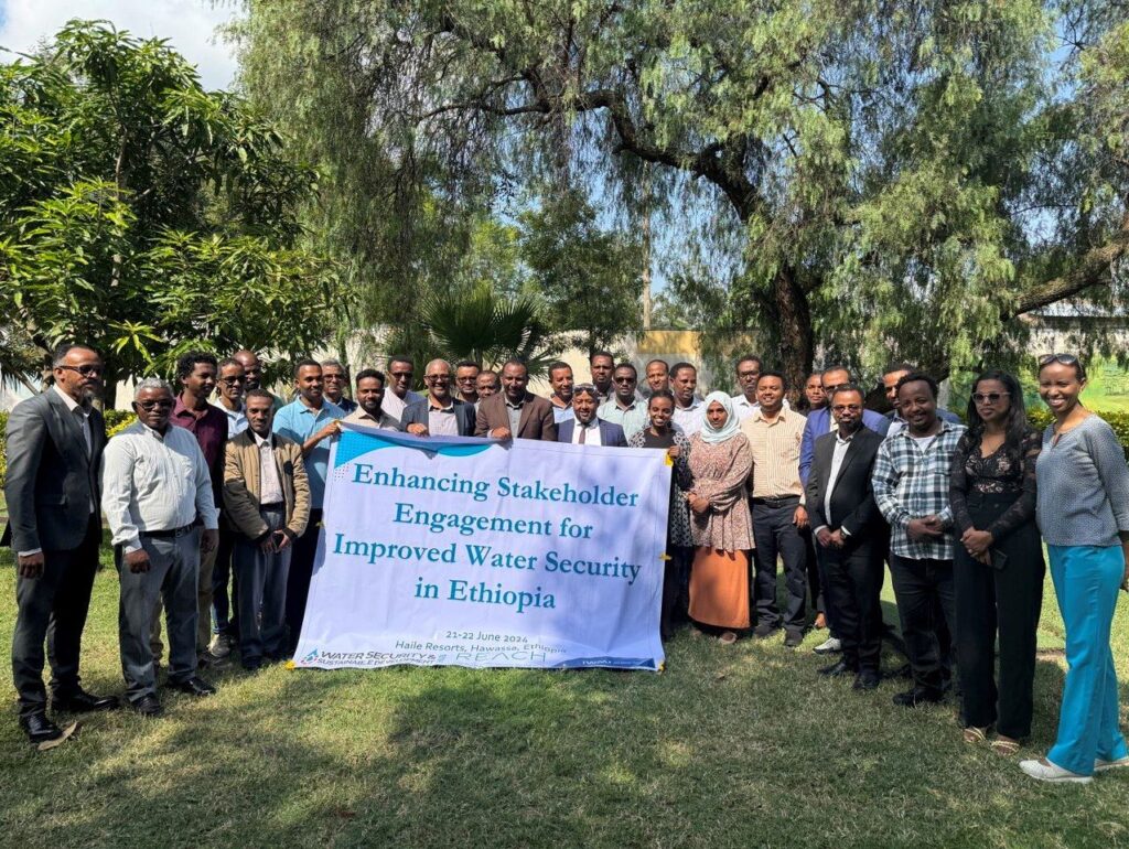 Workshop participants holding banner "Enhancing Stakeholder Engagement for Improved Water Security in Ethiopia"