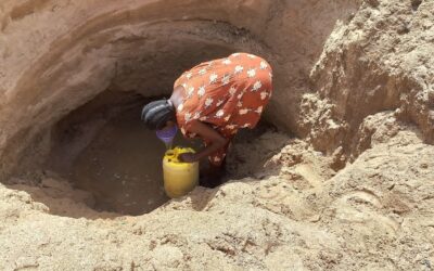 Woman fetching water in a dug-out dry Kawalase river bed. Photo taken by Mercy Mbithe